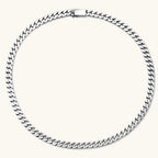 Polished 925 sterling silver Cuban link chain necklace, 550mm length, shown flat and draped on cream background.