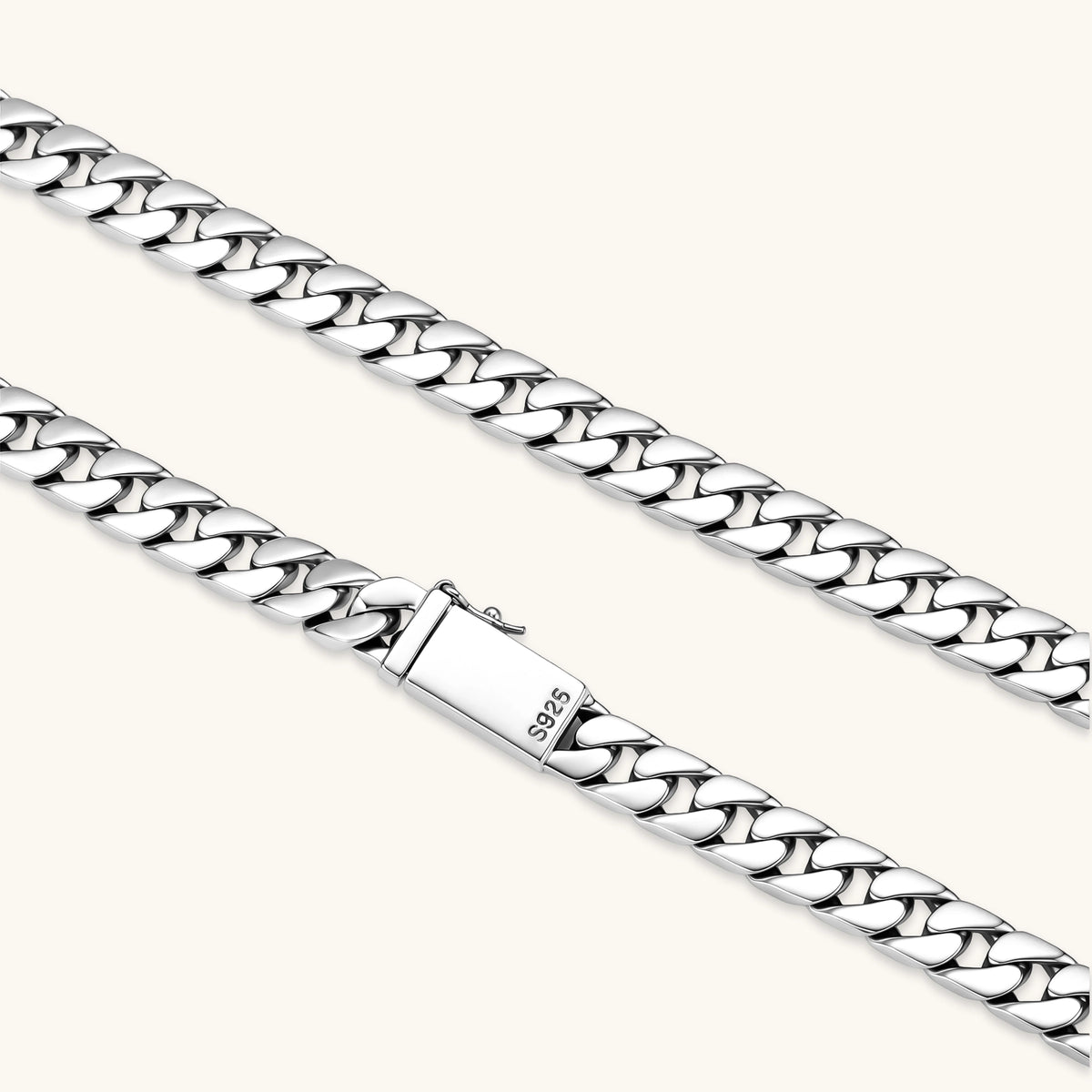 Polished 925 sterling silver Cuban link chain necklace, 550mm length, shown flat and draped on cream background.