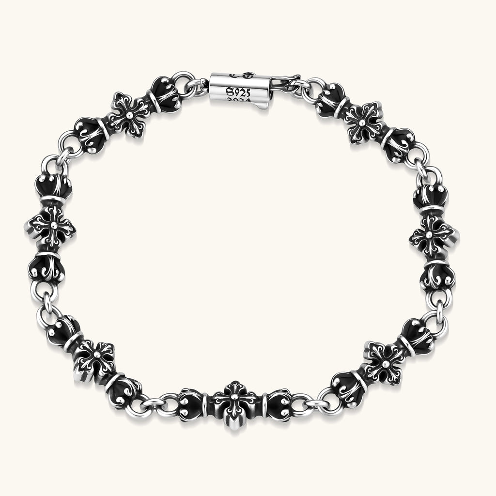 Oxidized 925 sterling silver bracelet with fleur-de-lis cross links, black-accented beads, and a cylindrical clasp stamped 2024.