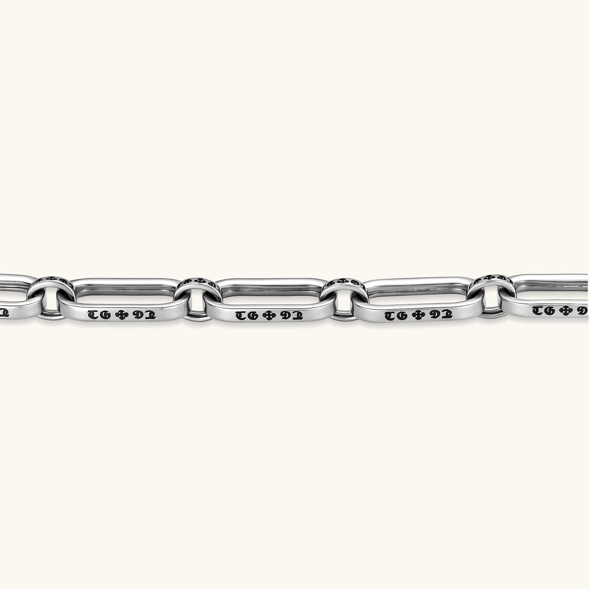 Sterling silver bar-link chain bracelet with oxidized Gothic text engravings and toggle clasp, 7.3mm wide, on white background.