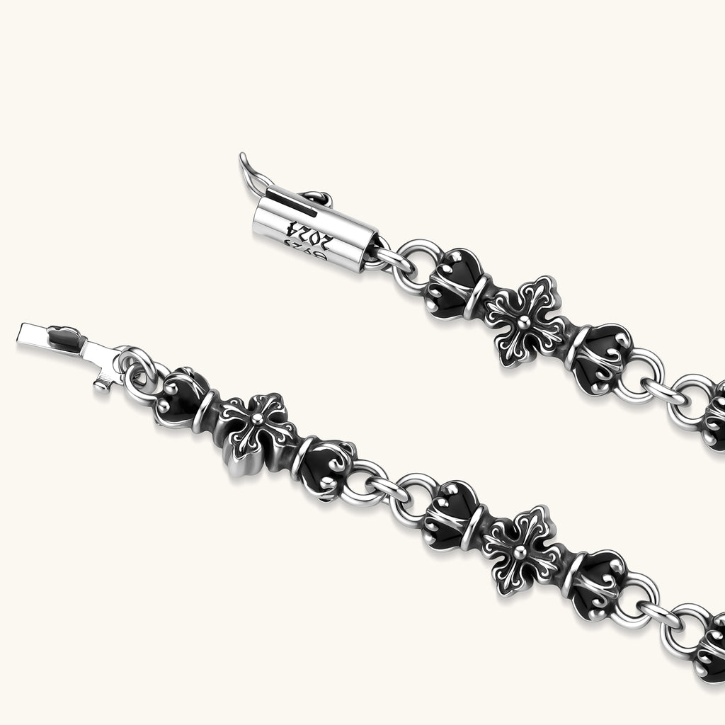 Oxidized 925 sterling silver bracelet with fleur-de-lis cross links, black-accented beads, and a cylindrical clasp stamped 2024.