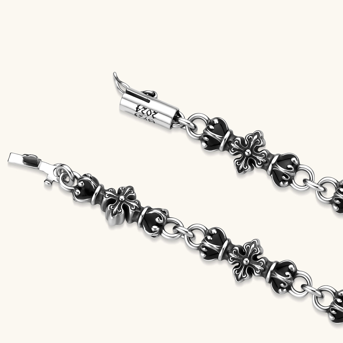 Oxidized 925 sterling silver bracelet with fleur-de-lis cross links, black-accented beads, and a cylindrical clasp stamped 2024.
