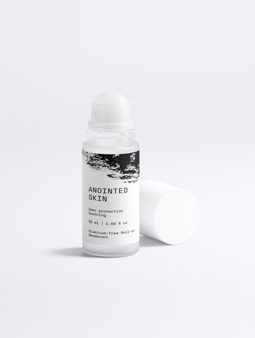 Anointed Garments aluminum-free roll-on deodorant in a white bottle with minimalist black and white label design.