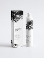 Anointed Garments Anointed Skin Anti-Age Day Cream bottle and box with white packaging and black abstract brushstroke art.