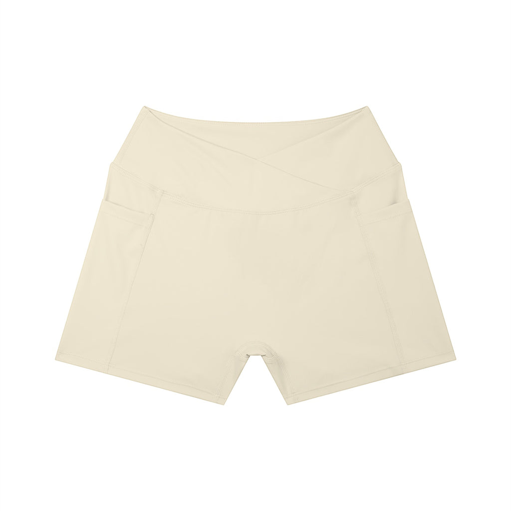 Anointed Garments beige high-rise yoga shorts with side pockets and a flattering crossover waistband design.