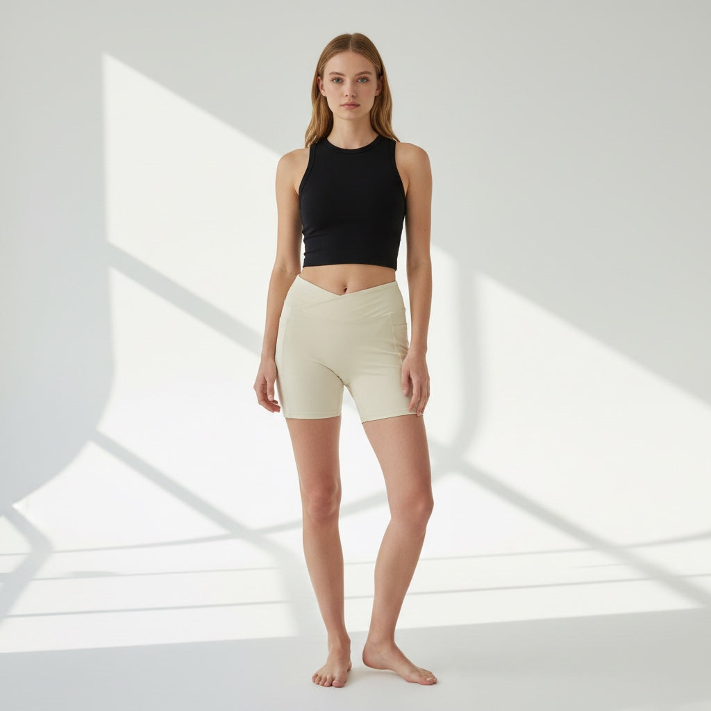 Model wearing Anointed Garments high-waisted beige athletic shorts with a crossover waistband and side pockets