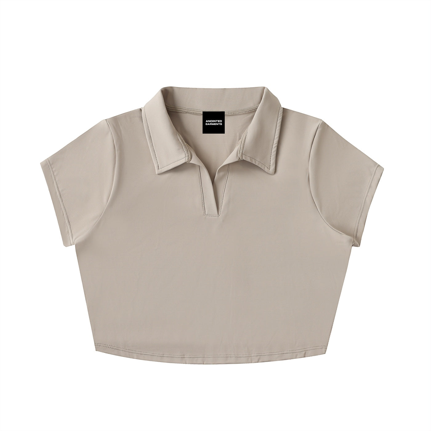 Anointed Garments beige V-neck lapel crop top in a sporty nylon-spandex blend with short sleeves.