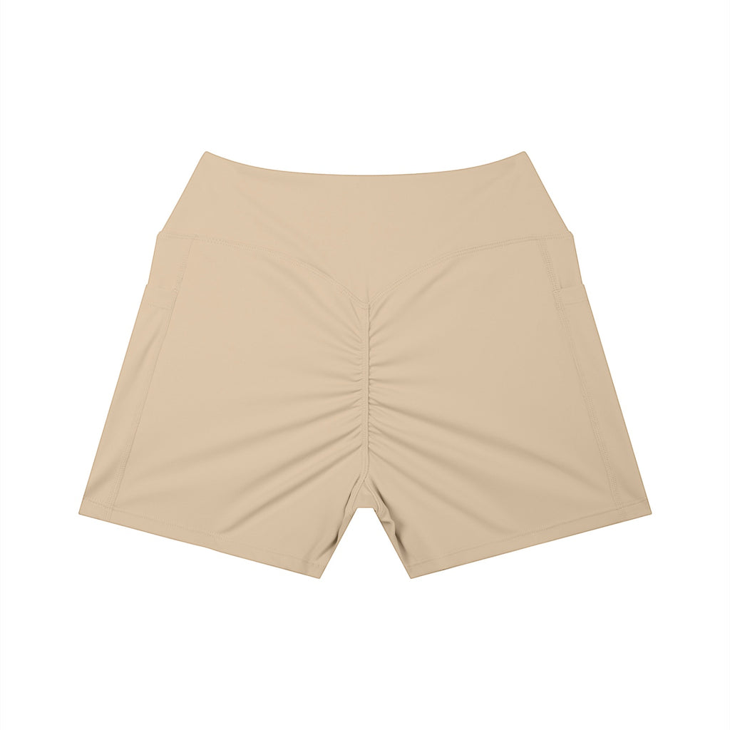 Anointed Garments beige high-waisted athletic shorts with a ruched back and side pockets for a sculpted performance fit.