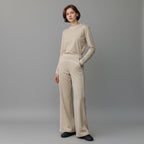 Model wearing Anointed Garments beige high-waisted wide-leg trousers with white contrast piping and matching top