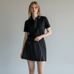 Anointed Garments women's black athletic performance skort with white piping and side slit, worn with matching polo.