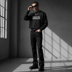 Model wearing an Anointed Garments black cropped crewneck sweatshirt with white chest branding and black jeans.