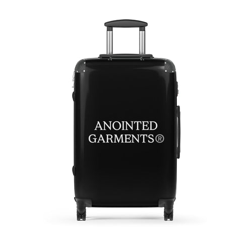 Anointed Garments black hard shell rolling suitcase with a textured finish, spinner wheels, and telescopic handle.
