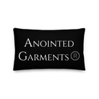 Anointed Garments black rectangular accent pillow with white brand logo and textured linen-feel polyester fabric.