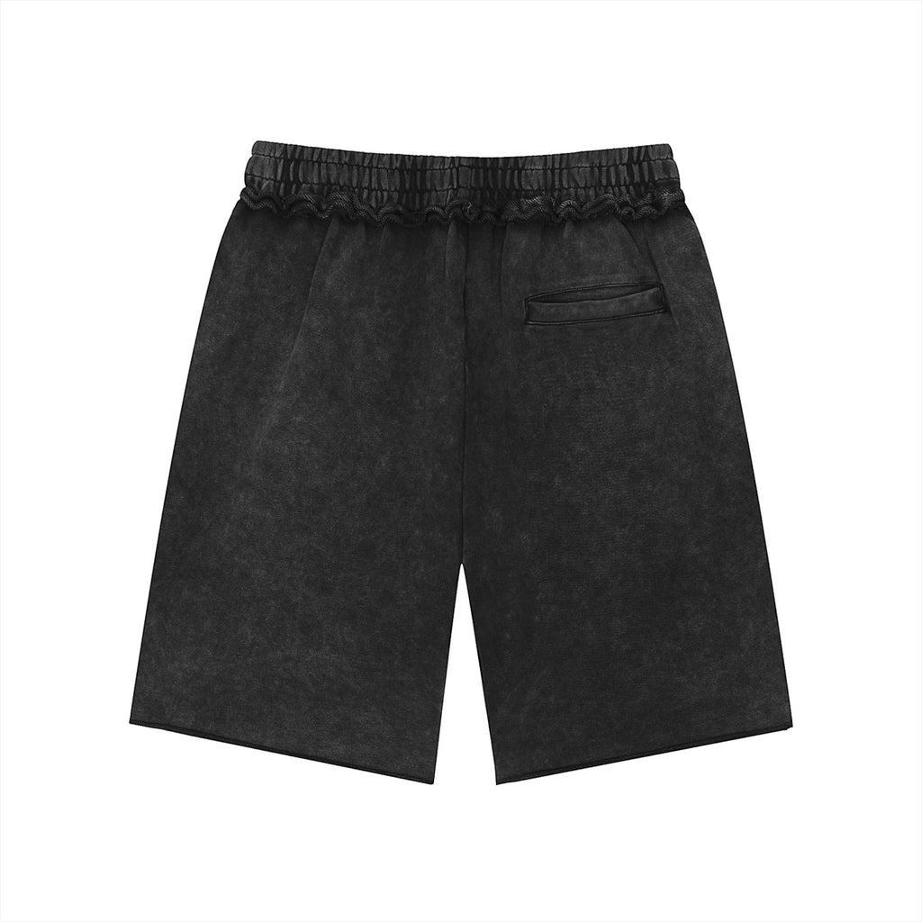 Anointed Garments unisex black mineral wash cotton shorts with a mid-waist, loose fit, and raw edge hem detail.