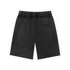 Anointed Garments unisex black mineral wash cotton shorts with a mid-waist, loose fit, and raw edge hem detail.