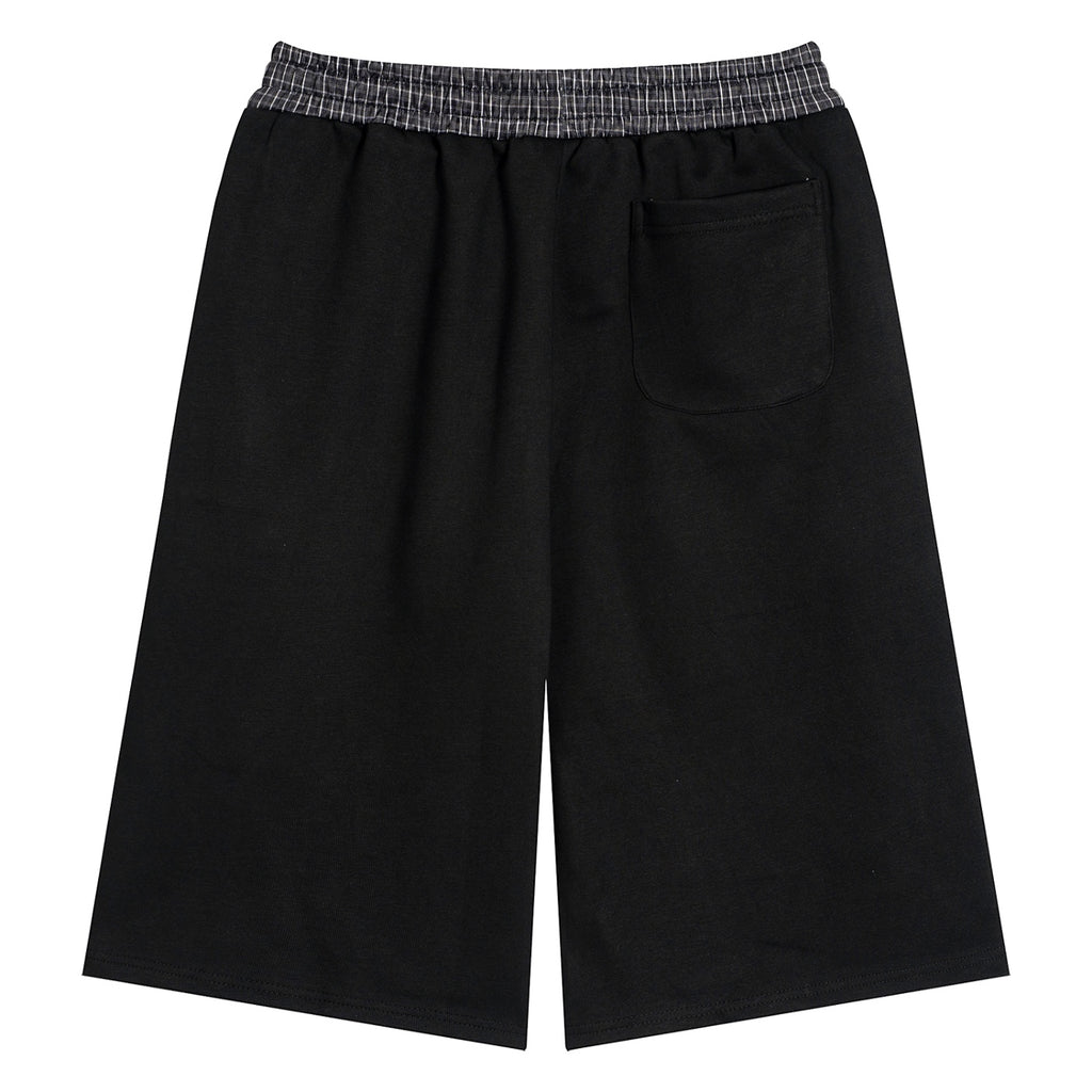 Anointed Garments black lounge shorts with a plaid elastic waistband and a rear patch pocket, back view.