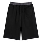 Anointed Garments black lounge shorts with a plaid elastic waistband and a rear patch pocket, back view.
