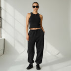 Model wearing Anointed Garments black vintage-wash sleeveless crop tank top with matching joggers and sunglasses
