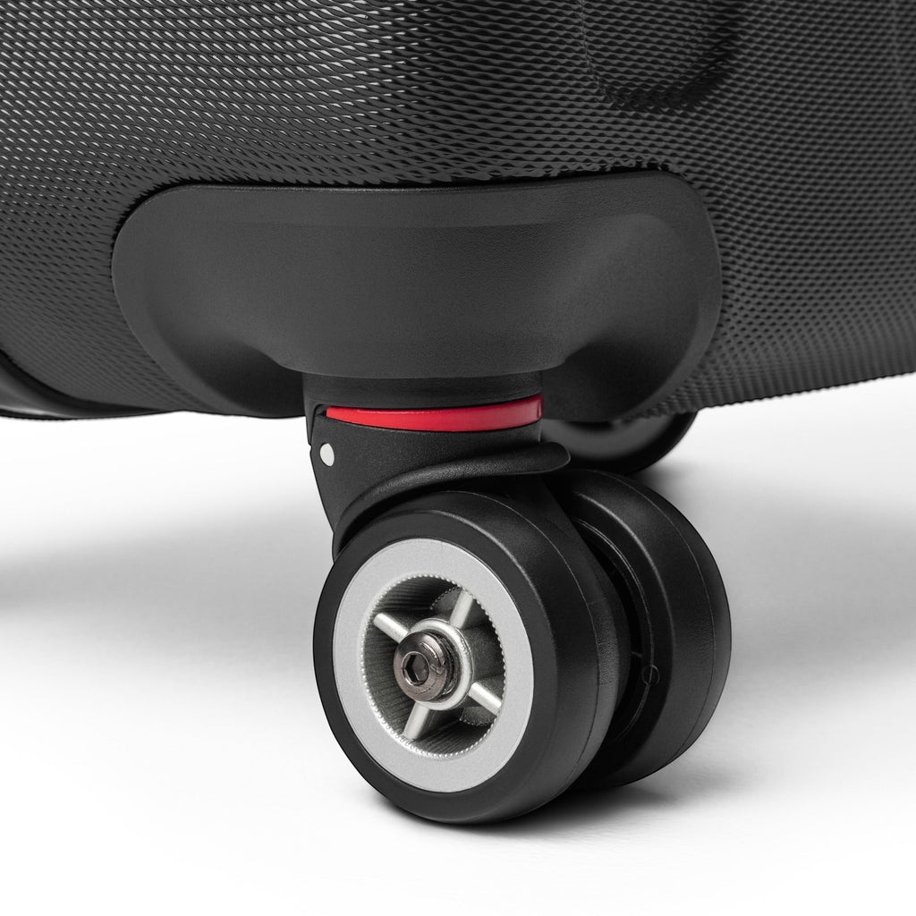 Anointed Garments black hard shell suitcase featuring a durable 360-degree spinner wheel with red accent detail.