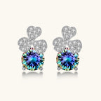 Anointed Garments blue clover moissanite stud earrings in platinum-plated sterling silver with round brilliant stones.