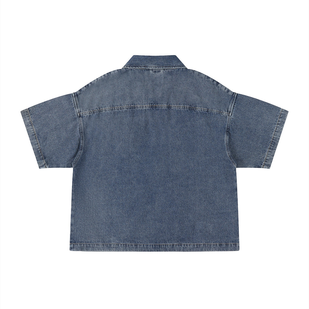 Back view of Anointed Garments short sleeve denim shirt in blue with a relaxed, boxy fit and classic collar.