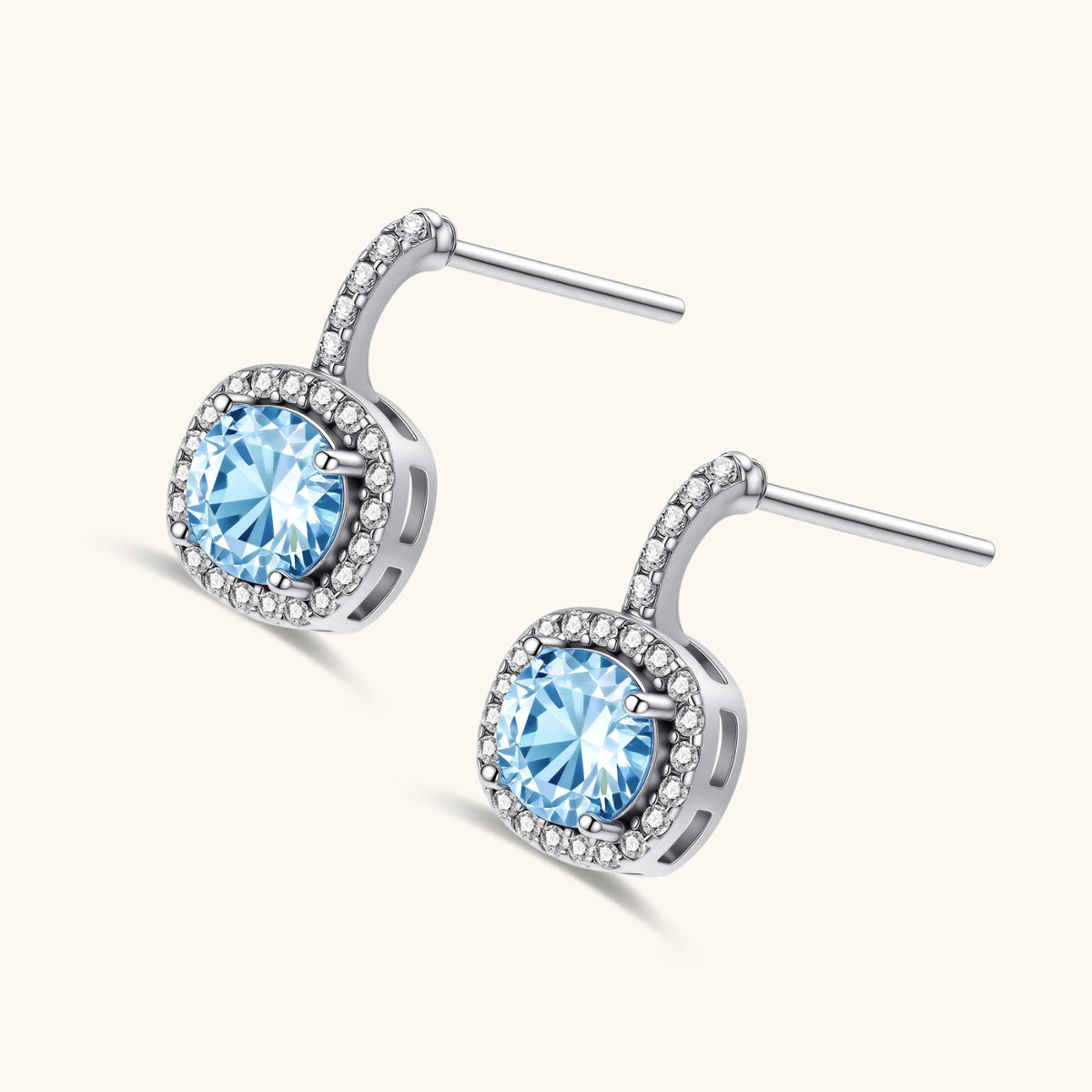 Anointed Garments Celestial Halo drop earrings featuring round blue moissanite stones in platinum-plated silver settings.