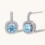 Anointed Garments Celestial Halo drop earrings featuring round blue moissanite stones in platinum-plated silver settings