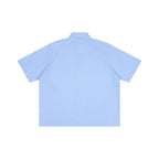 Back view of an Anointed Garments light blue striped boxy short sleeve shirt with a lapel collar.