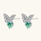 Anointed Garments butterfly stud earrings in platinum-plated sterling silver with green moissanite and clear accents.