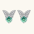 Anointed Garments butterfly stud earrings in platinum-plated sterling silver with round moissanite and green accents.