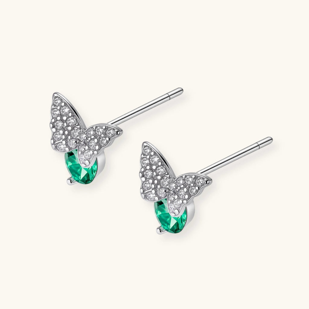 Anointed Garments butterfly stud earrings in platinum-plated sterling silver with green moissanite and clear accents.