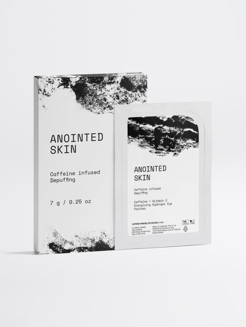 Anointed Garments Anointed Skin caffeine and vitamin C hydrogel eye patch box and single-use sachet in white packaging.