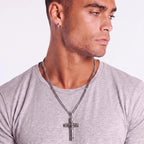 Anointed Garments Celtic cross necklace with filigree knotwork on a stainless steel chain worn by a man