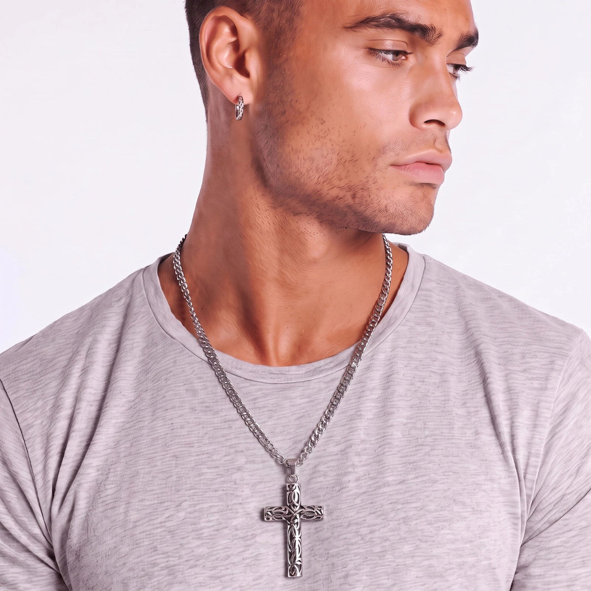 Anointed Garments Celtic cross necklace with filigree knotwork on a stainless steel chain worn by a man