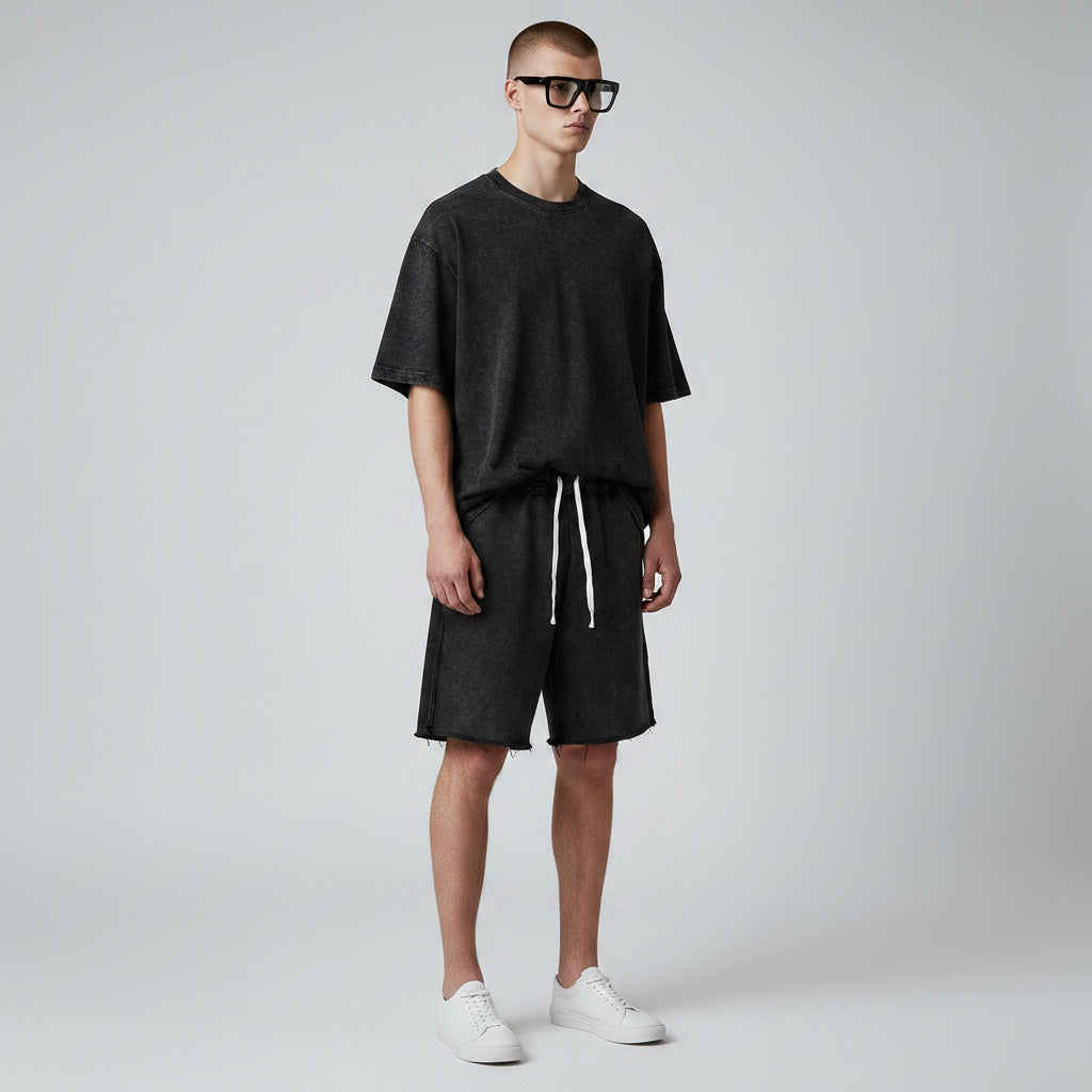 Model wearing Anointed Garments charcoal acid-wash cotton lounge shorts with raw-edge hem and drawstring waist
