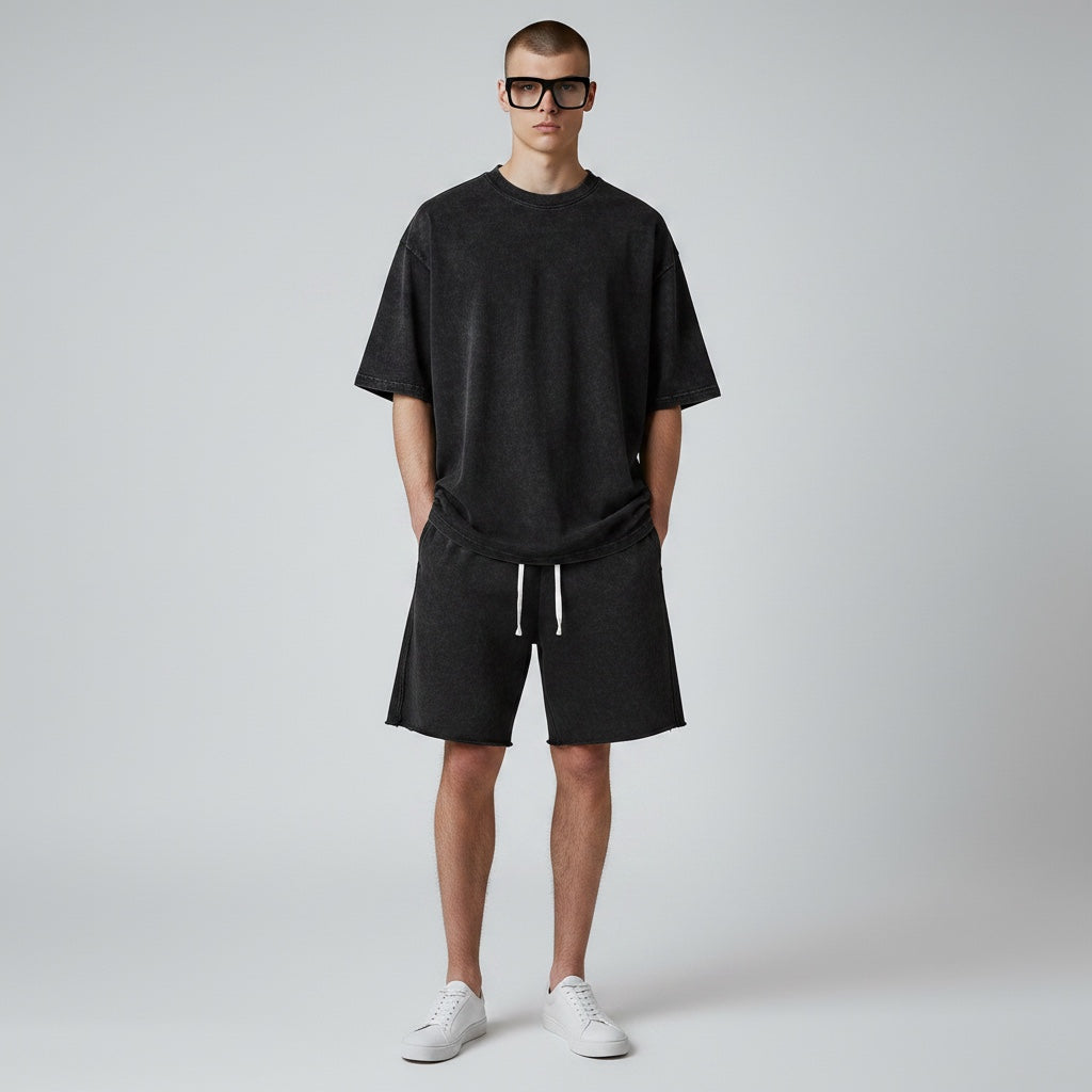 Model wearing Anointed Garments charcoal acid-wash cotton lounge shorts with a drawstring waist and raw-edge hem.