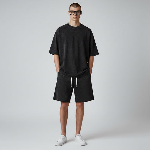 Model wearing Anointed Garments charcoal acid-wash cotton lounge shorts with a drawstring waist and raw-edge hem.
