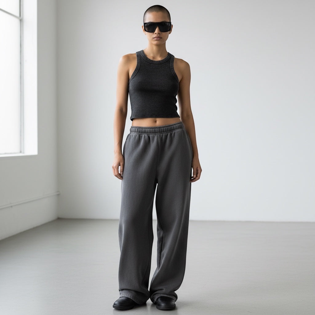 Model wearing Anointed Garments charcoal grey vintage-wash sleeveless crop tank top with matching wide-leg sweatpants.