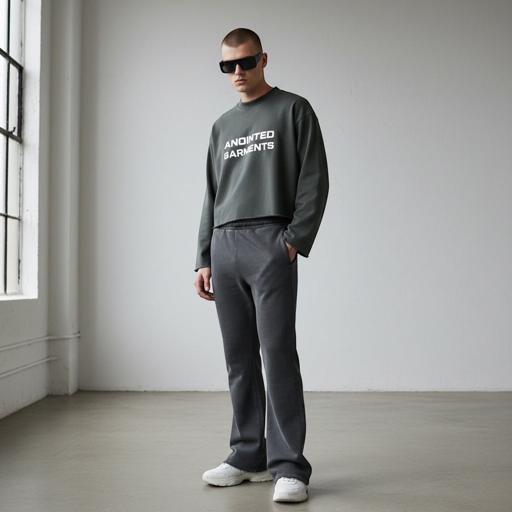 Model wearing Anointed Garments charcoal grey cropped crewneck sweatshirt with white logo and matching sweatpants