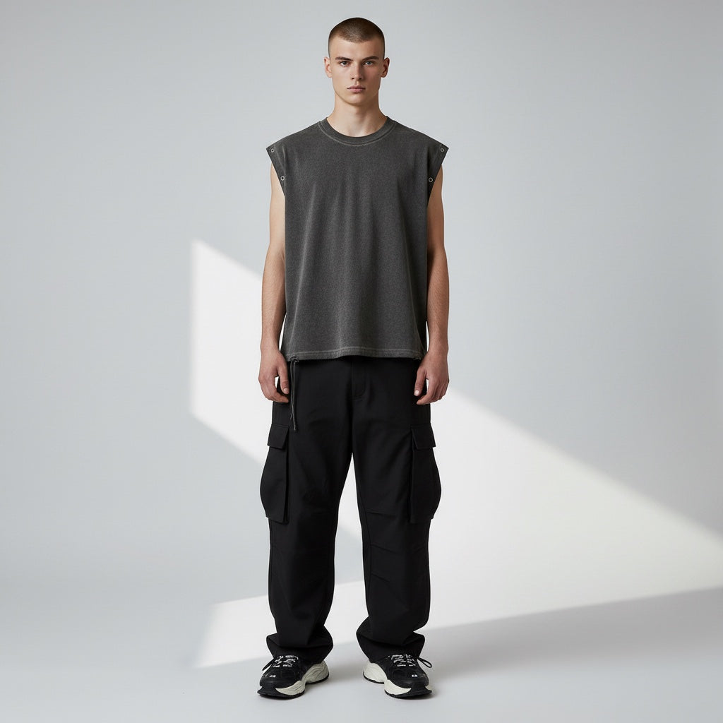 Model wearing Anointed Garments charcoal grey sleeveless cotton tank top with metal grommets and distressed hem