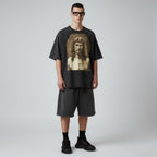 Model wearing an Anointed Garments charcoal black vintage-wash cotton graphic t-shirt with raglan sleeves and shorts.