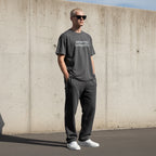 Model wearing an Anointed Garments charcoal grey oversized cotton t-shirt with logo, paired with matching joggers.