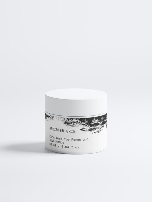 Anointed Garments Anointed Skin clay mask for pores and blackheads in a white jar with black textured label design.