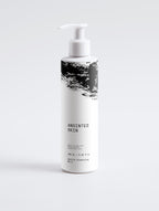 Anointed Garments Anointed Skin Silky Soft Cleansing Milk in a white pump bottle with black abstract graphic design.