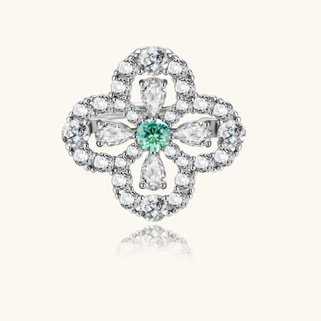 Anointed Garments platinum-plated sterling silver four-leaf clover ring with a central green moissanite stone.