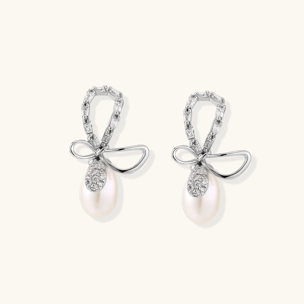 Anointed Garments crystal bow drop earrings featuring baguette-cut crystals and freshwater pearls in rhodium-plated silver