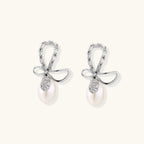 Anointed Garments crystal bow drop earrings featuring baguette-cut crystals and freshwater pearls in rhodium-plated silver