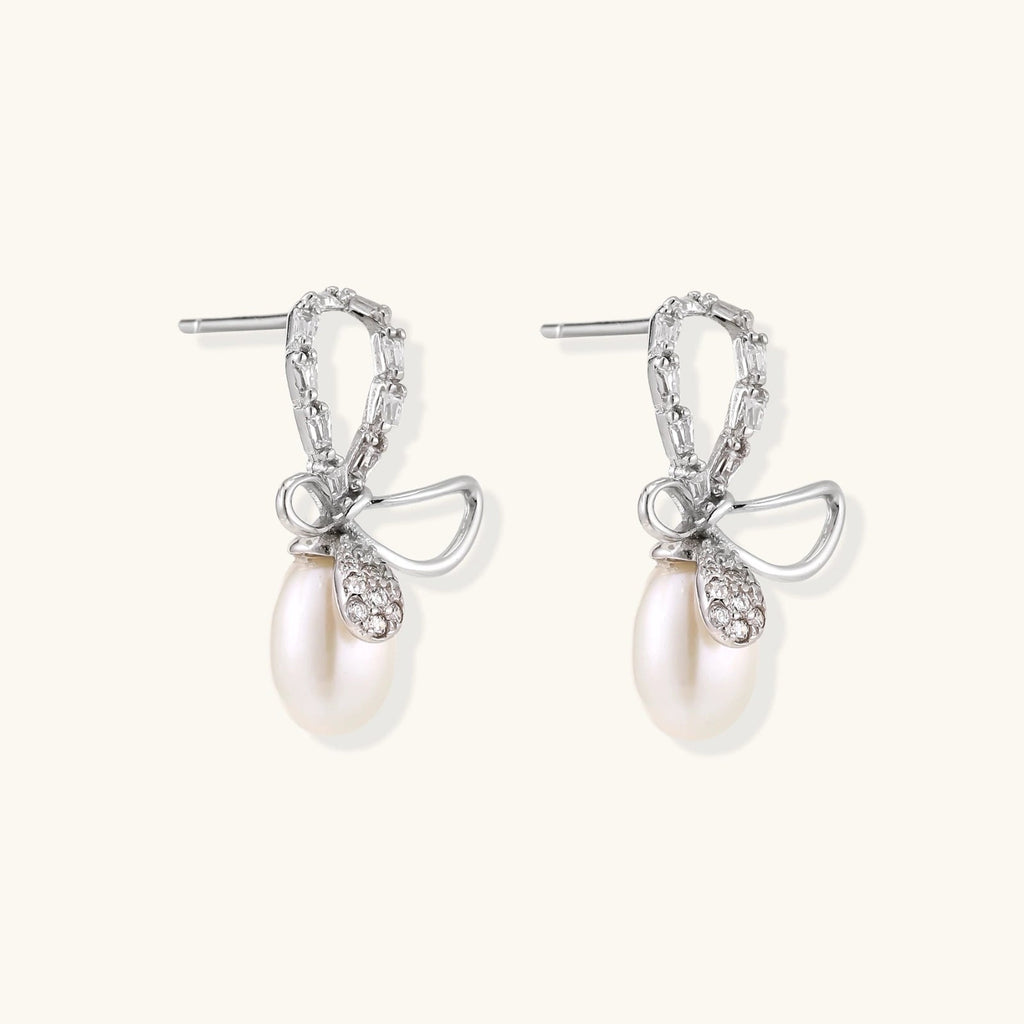 Anointed Garments Crystal Bow Pearl Drop earrings in rhodium-plated sterling silver with baguette-cut crystal accents.