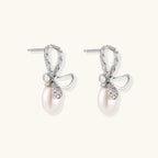 Anointed Garments Crystal Bow Pearl Drop earrings in rhodium-plated sterling silver with baguette-cut crystal accents.
