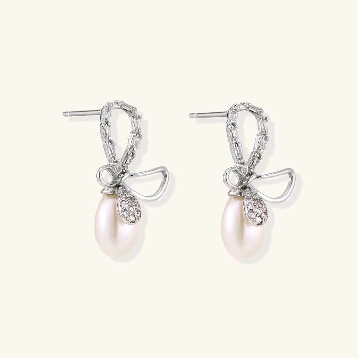 Anointed Garments Crystal Bow Pearl Drop earrings in rhodium-plated sterling silver with baguette-cut crystal accents.